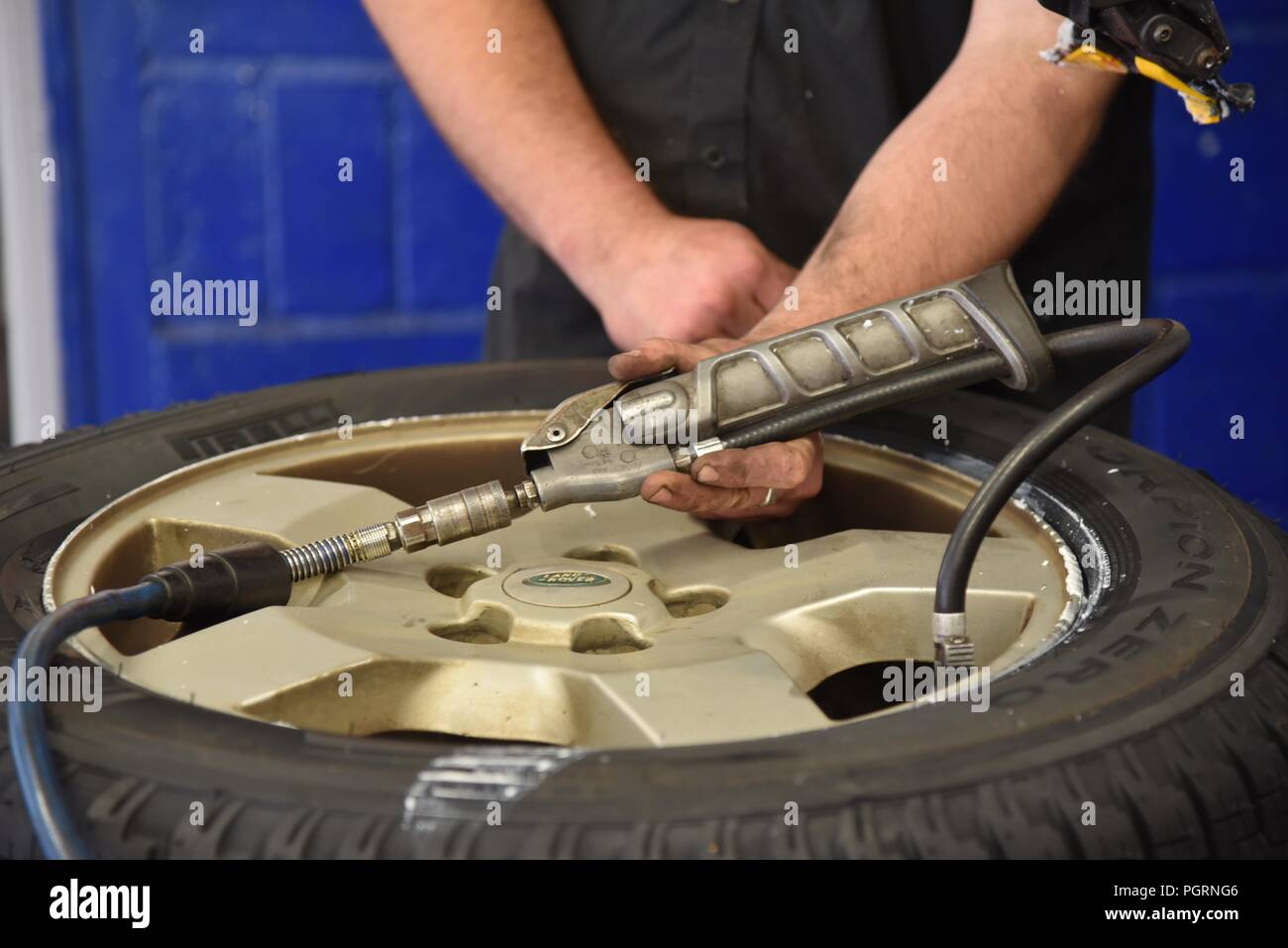 Tyre/tire fitting a newly fitted tyre being inflated for the first