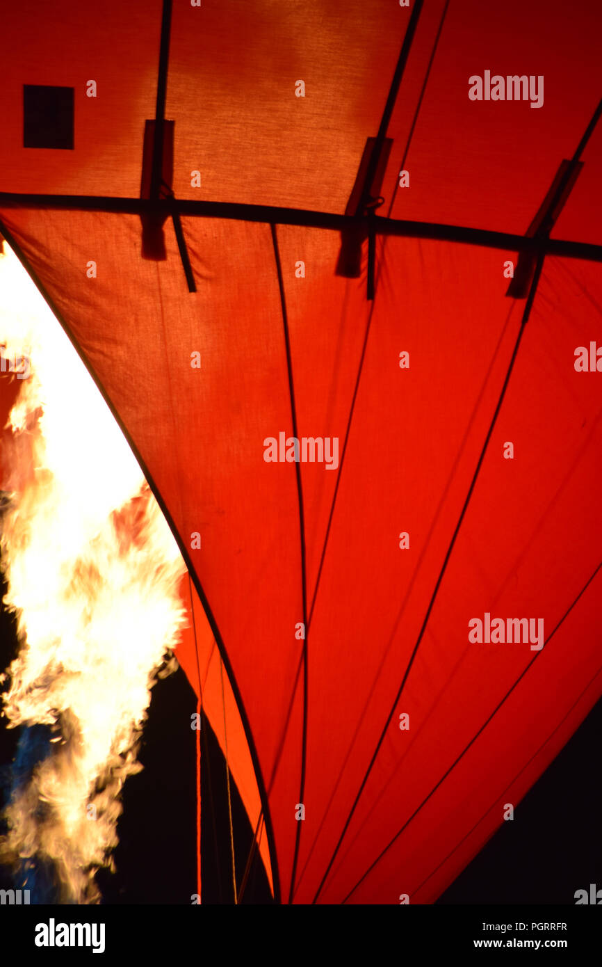hot air balloon with a yellow fire from a burner by night, fire and hot air balloon Stock Photo