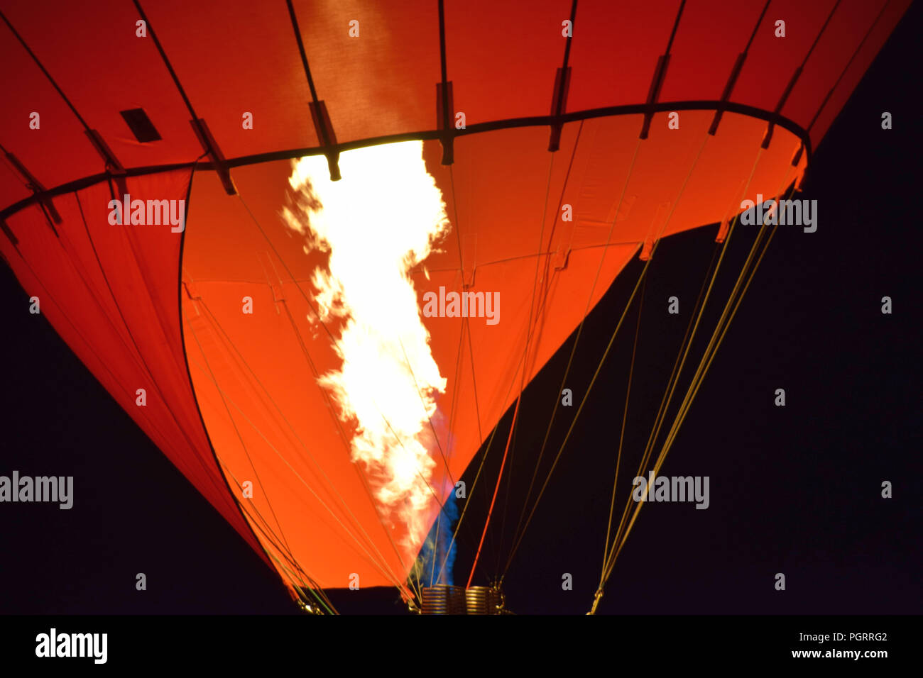 burner of a hot air balloon macro shot, hot air balloon with a yellow fire from a burner by night Stock Photo