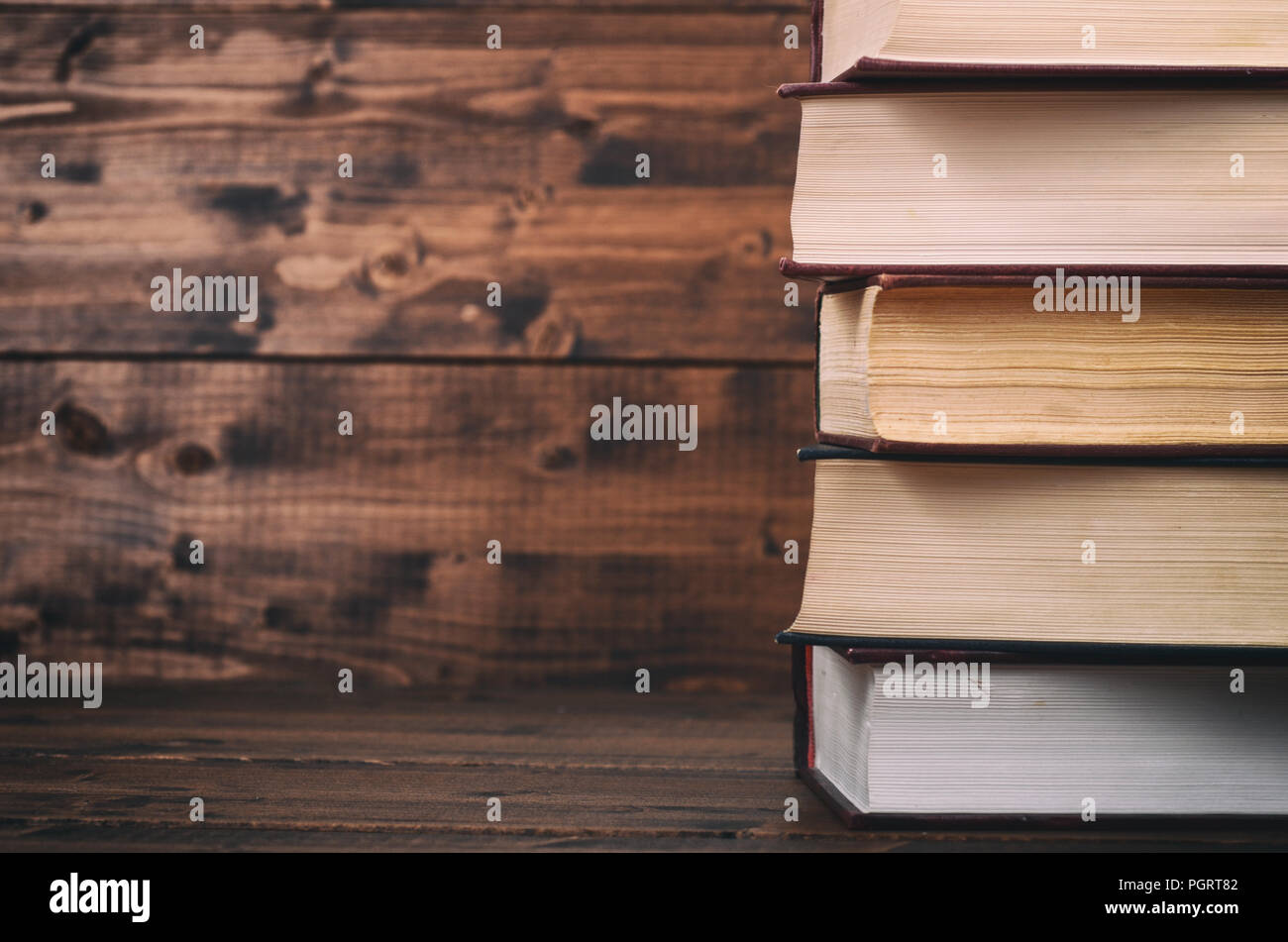 Old Law books on the brown wooden background, brown wooden backdrop Stock Photo