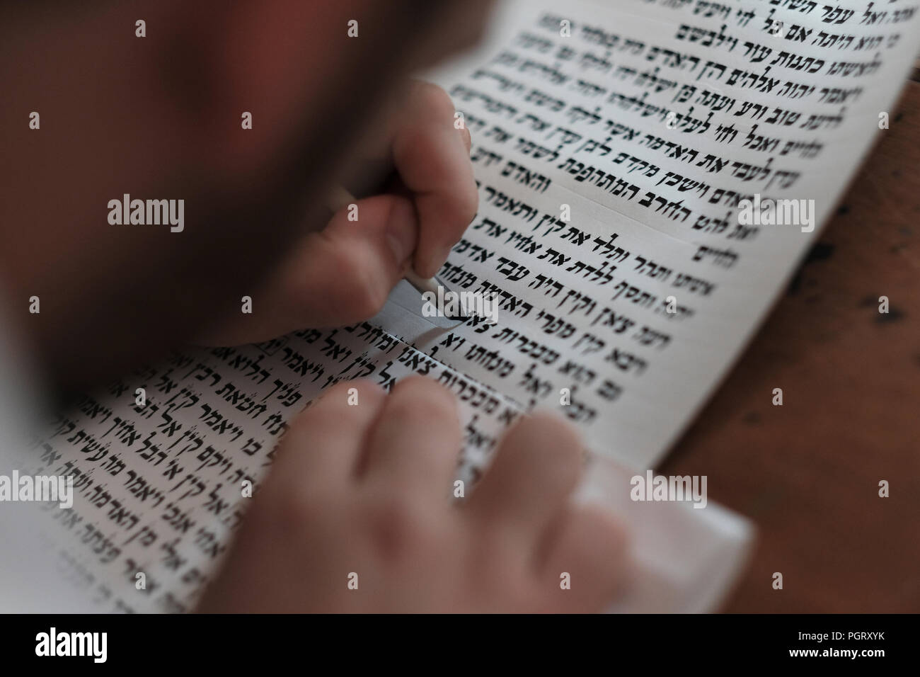 A religious Jewish "Stam" left handed calligrapher writing Hebrew