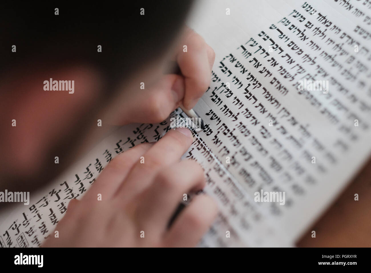 A religious Jewish "Stam" left handed calligrapher writing Hebrew