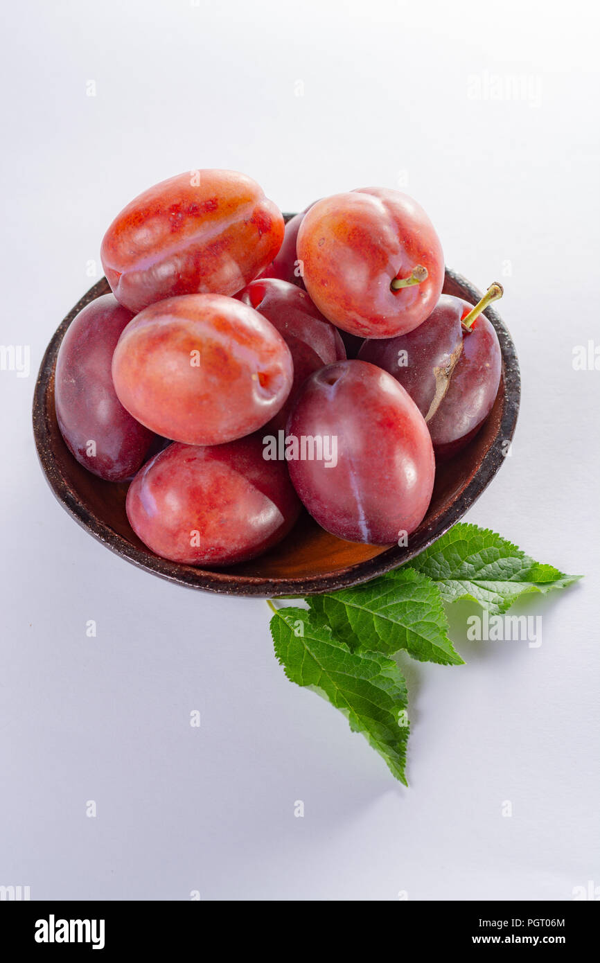 Group of ripe oval Victoria plums from England on white background with leaves Stock Photo Alamy