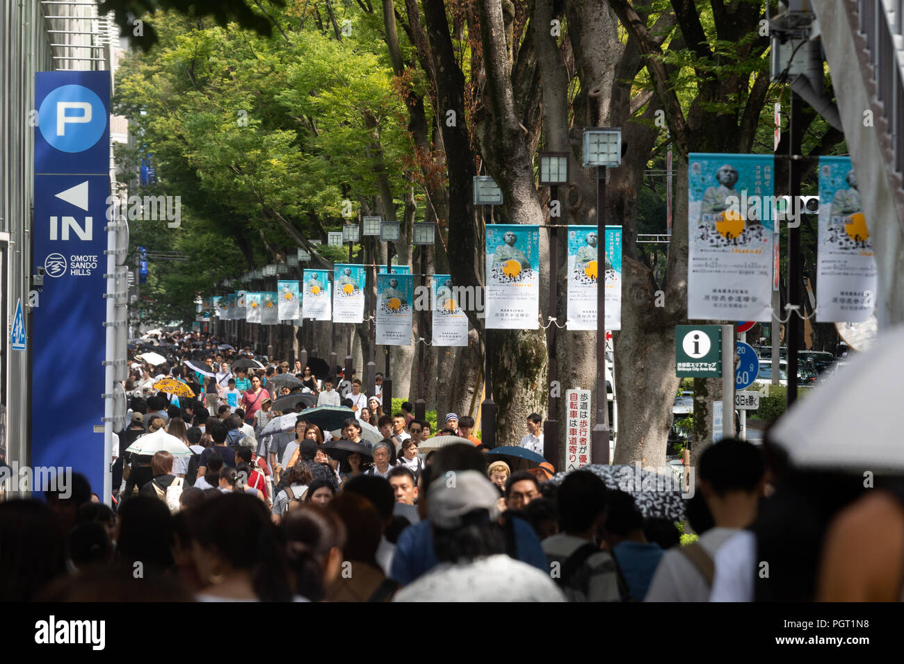 Tokyo residents and tourists crowd Omotesando, the shopping avenue on the city's Shinjuku Ward. Stock Photo