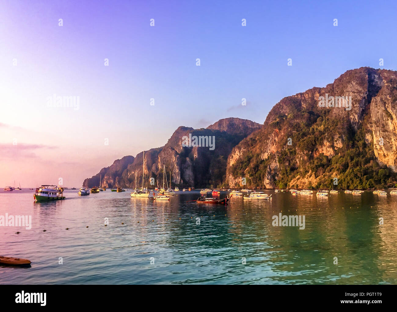 Digital painting of sunset sky and island with color reflected in the ...