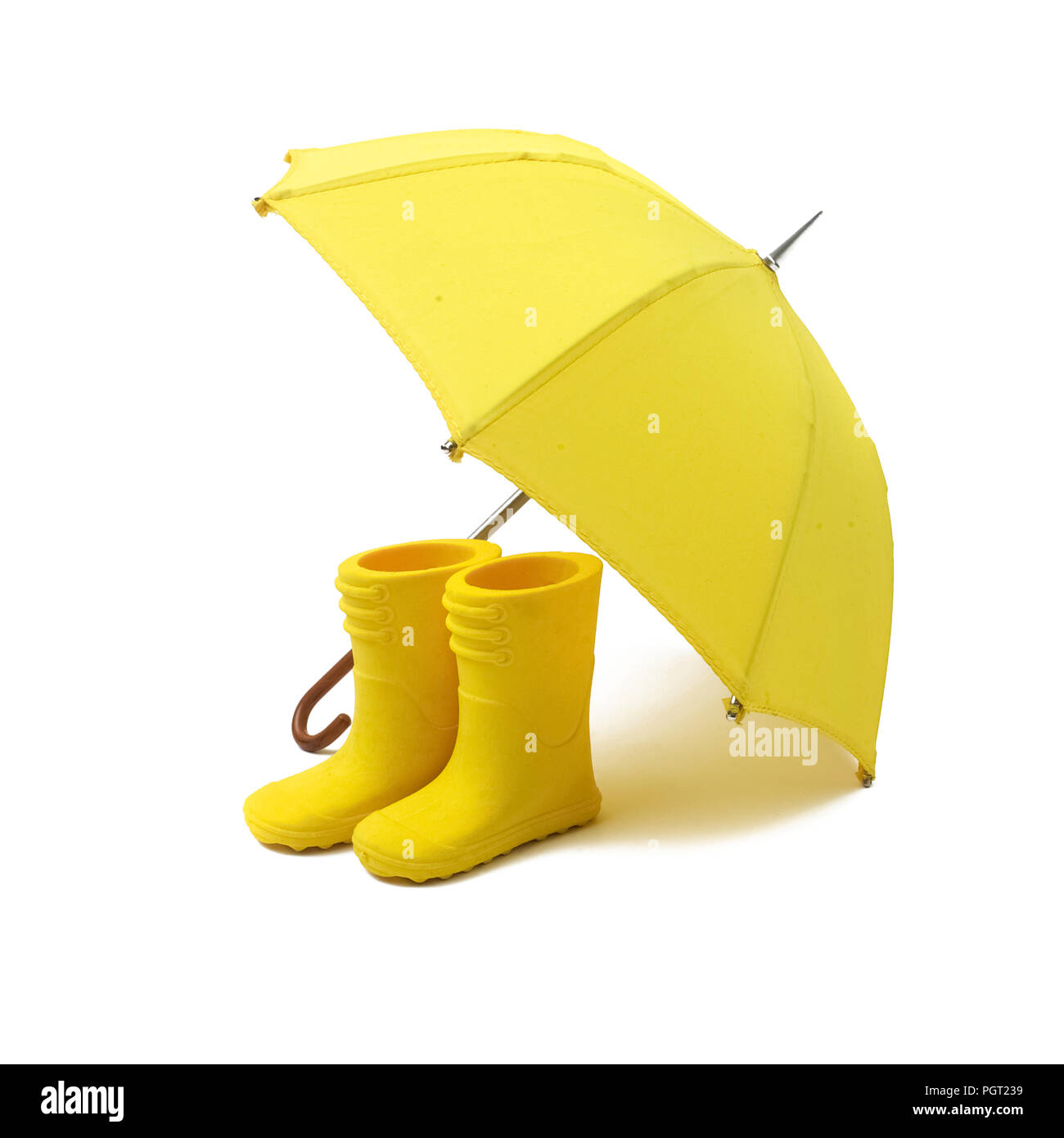 A pair of yellow rain boots and a umbrella on a white background Stock  Photo - Alamy