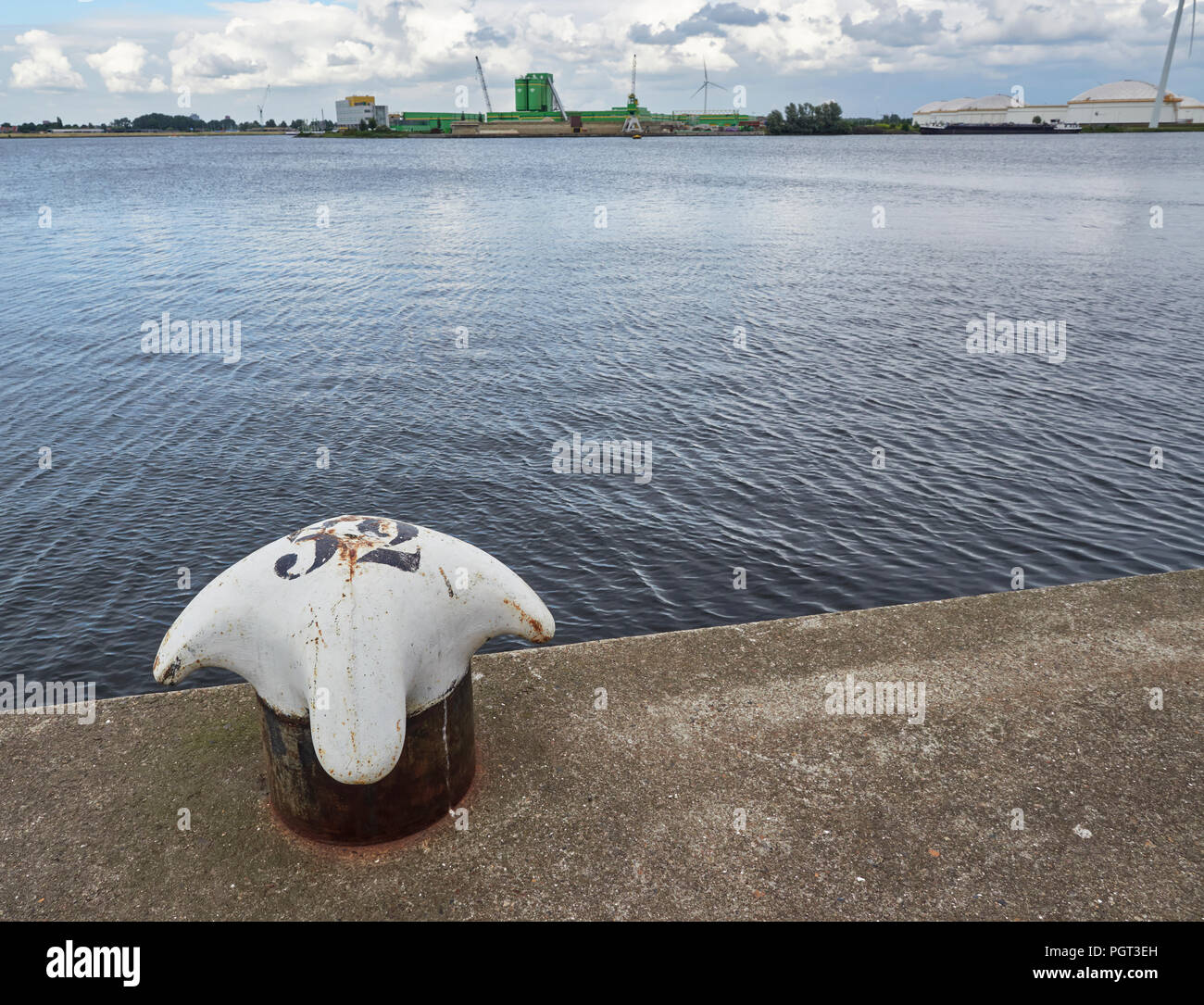 Looking across the North Sea Canal at the Liquid Storage Tanks and an Agricultural Chemical Complex in Den Haag Port near to Amsterdam, Holland. Stock Photo