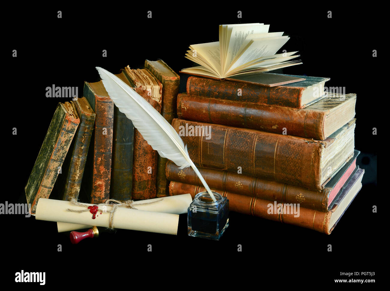 Still life with a letter, a pen and old books isolated on a black background Stock Photo