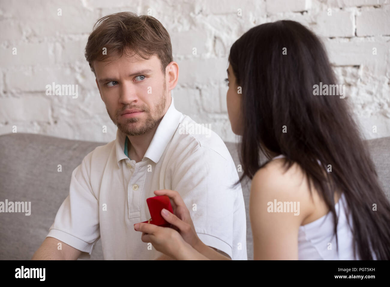 Decisive woman asking puzzled lover to marry her Stock Photo