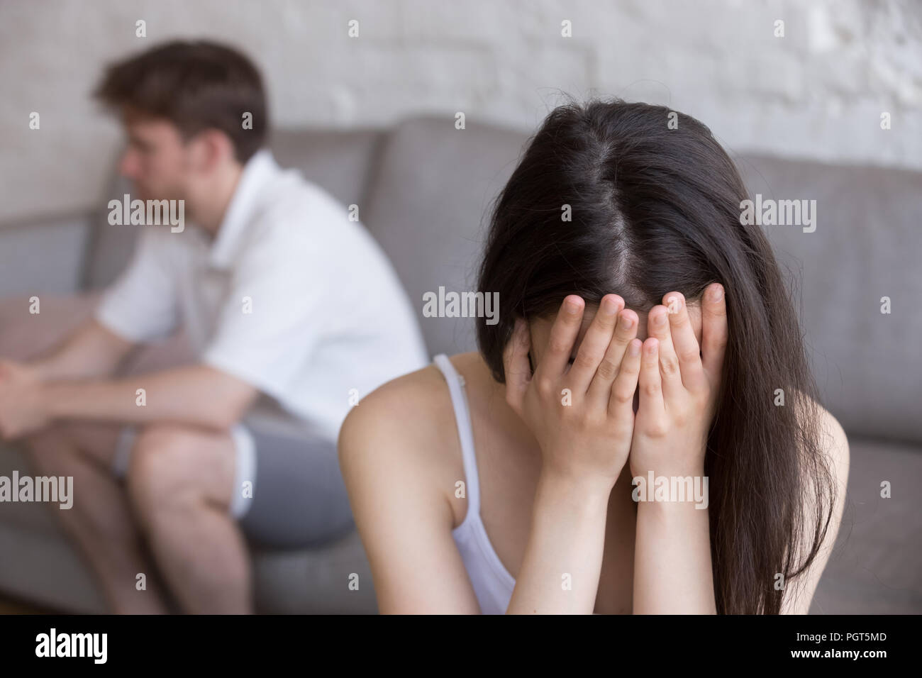 Sad girlfriend worried about relationship problems with lover Stock Photo