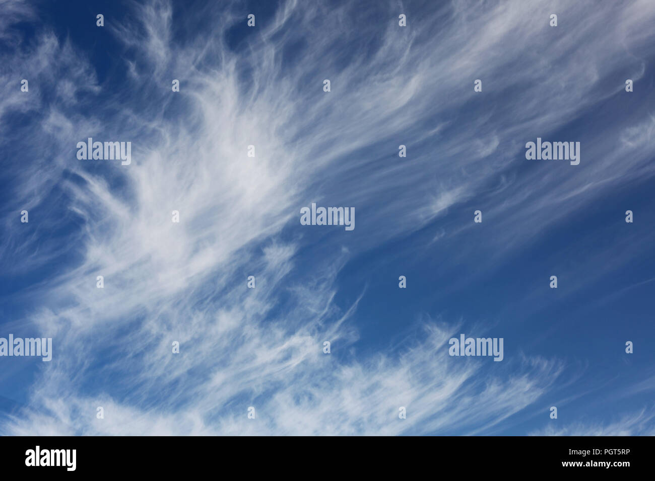 Wispy white clouds in a light blue sky Stock Photo - Alamy