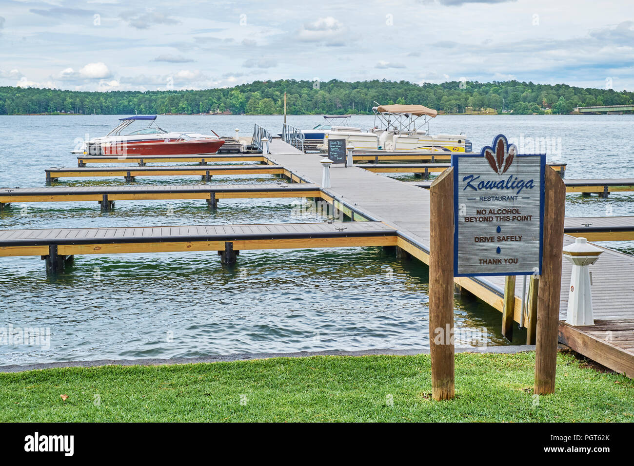 Boat dock with boats moored at Kowaliga Restaurant on Lake Martin, a
