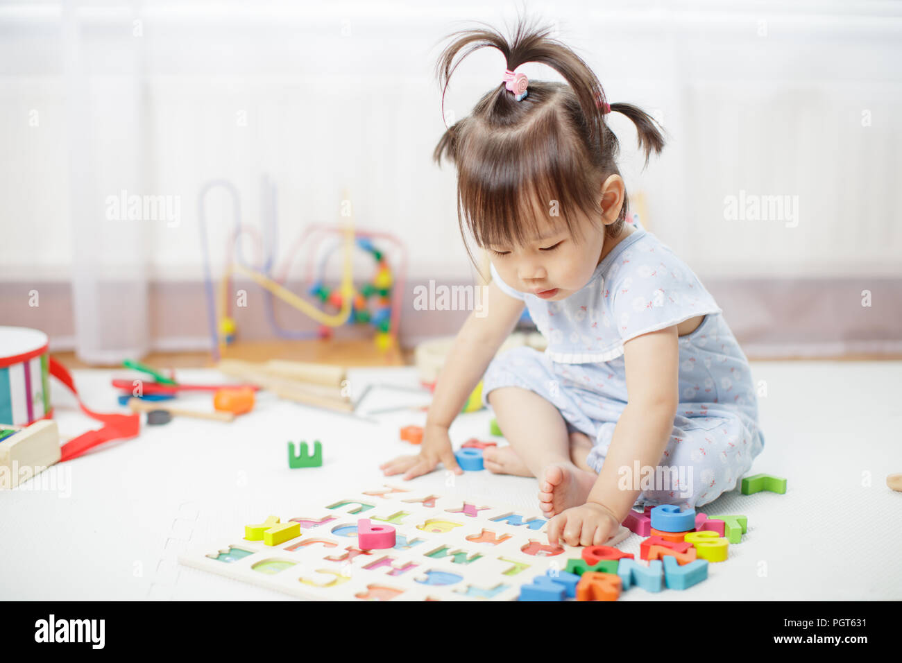 baby girl learning alphabet at home Stock Photo - Alamy