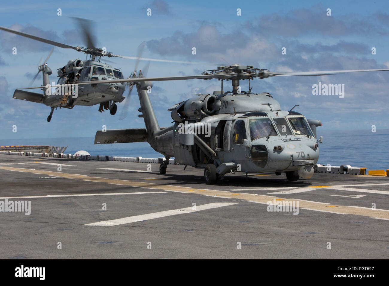 Two MH-60S Seahawks take off from a flight deck of the U.S.S. Kearsarge to observe and conduct a visit, board, search and seizure evolution at sea Aug. 27, 2018. Lt. Gen. Robert F. Hedelund, II Marine Expeditionary Force commanding general, and Vice Adm. Andrew Lewis, commander U.S. 2nd Fleet, were aboard to observe and discuss the joint partnership between II MEF and the 2nd Fleet. (U.S. Marine Corps photo by Pfc. Nicholas Guevara) Stock Photo