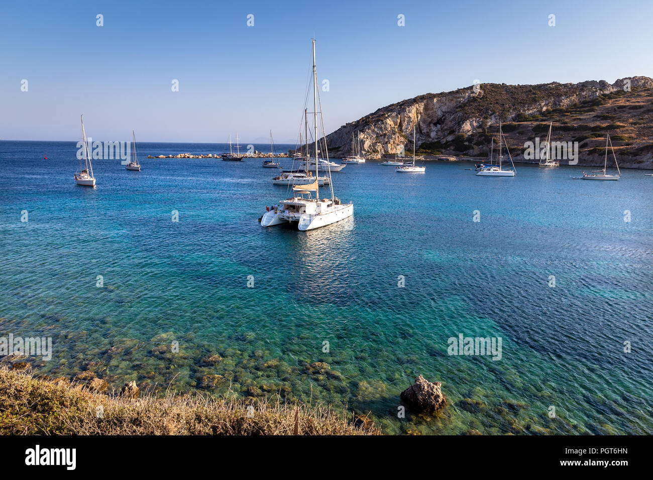 White catamaran docked in ancient bay of Knidos against blue sky. Datca peninsula, Mugla, Turkey. Stock Photo