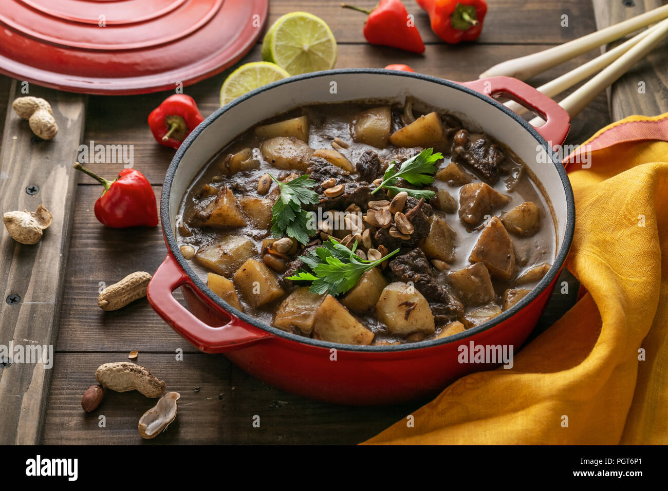 Delicious thai beef curry in a red pot, copy space Stock Photo