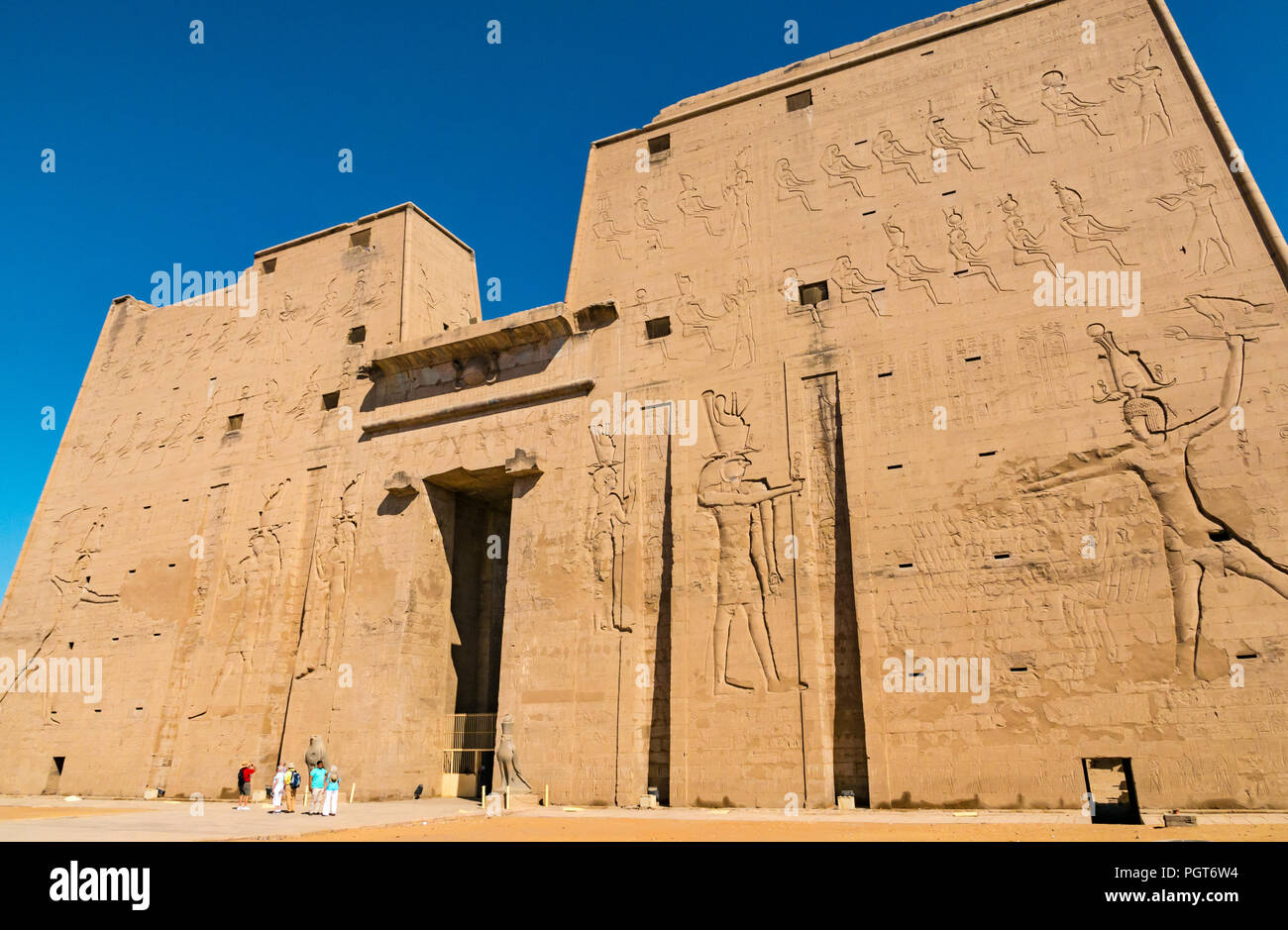 Egyptian carved figure hieroglyphs on entrance pylon of Temple of Horus, Edfu, Egypt, Africa Stock Photo