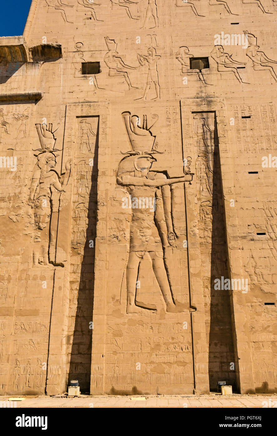 Egyptian carved figure hieroglyphs on entrance pylon of Temple of Horus, Edfu, Egypt, Africa Stock Photo