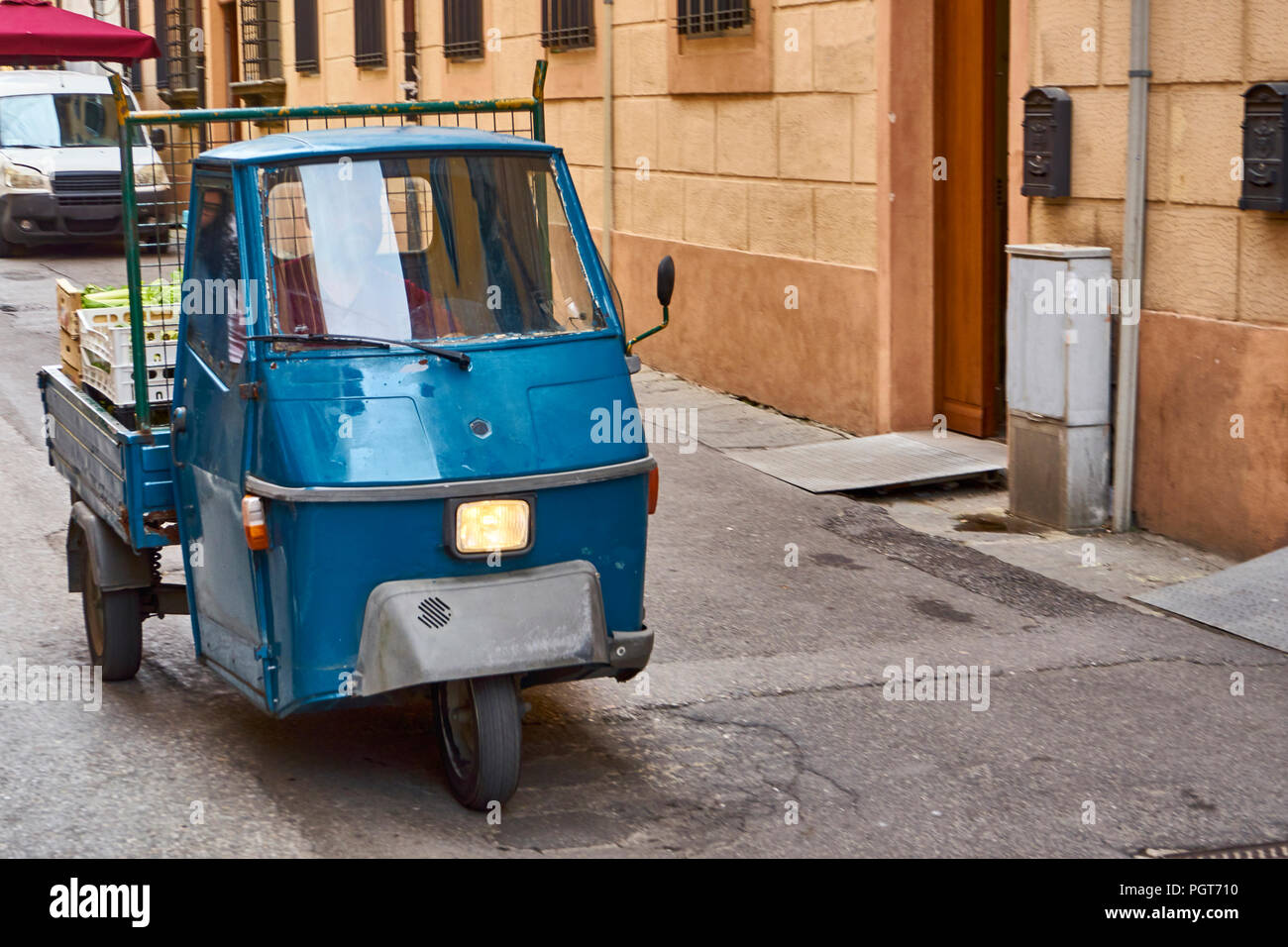 Blue Piaggio Ape Driving Through Old Italian Town Stock Photo - Alamy