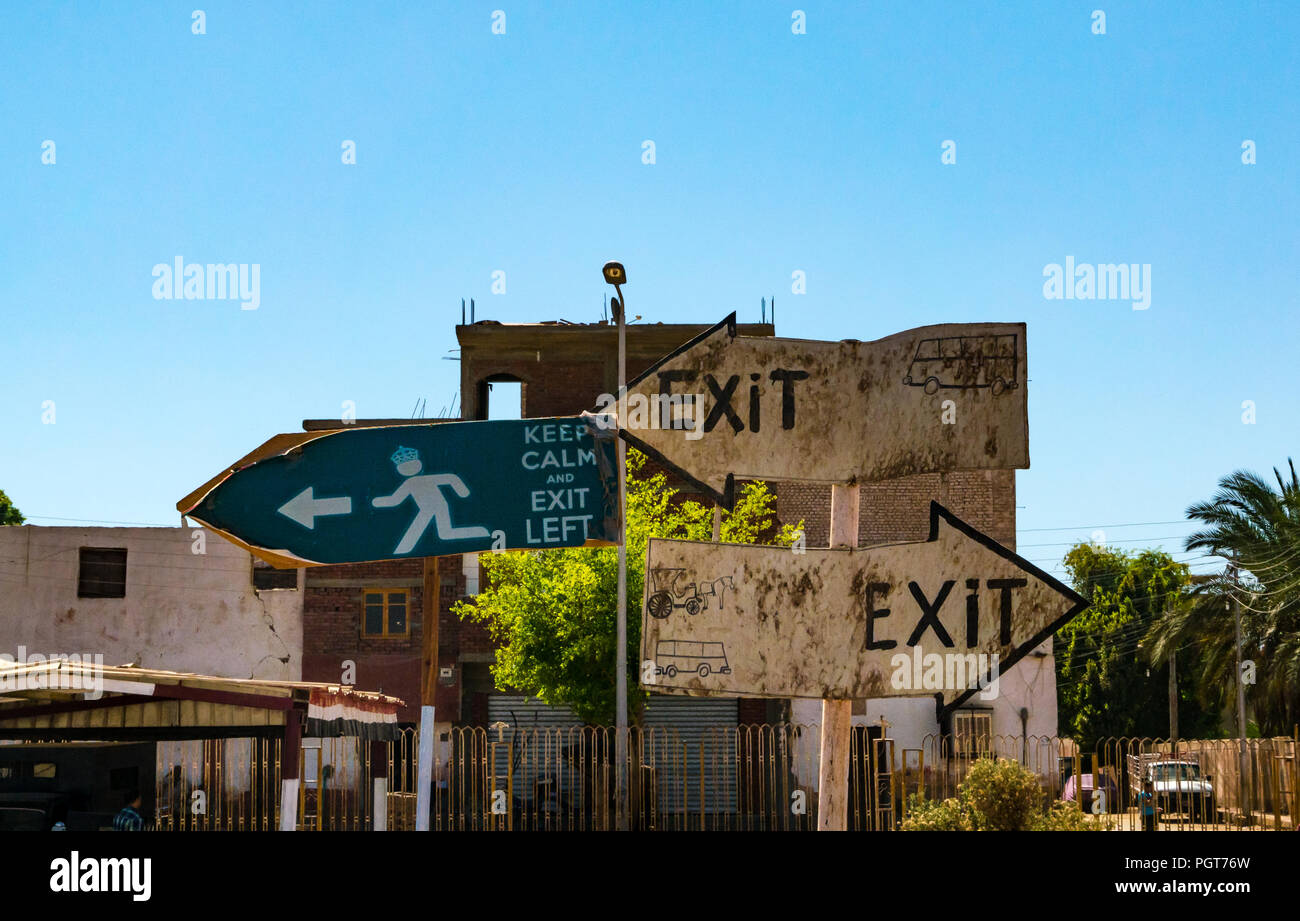 Dirty worn humorous quirky direction and exit signs for tourists at quayside with keep calm instruction, Edfu, Egypt, Africa Stock Photo