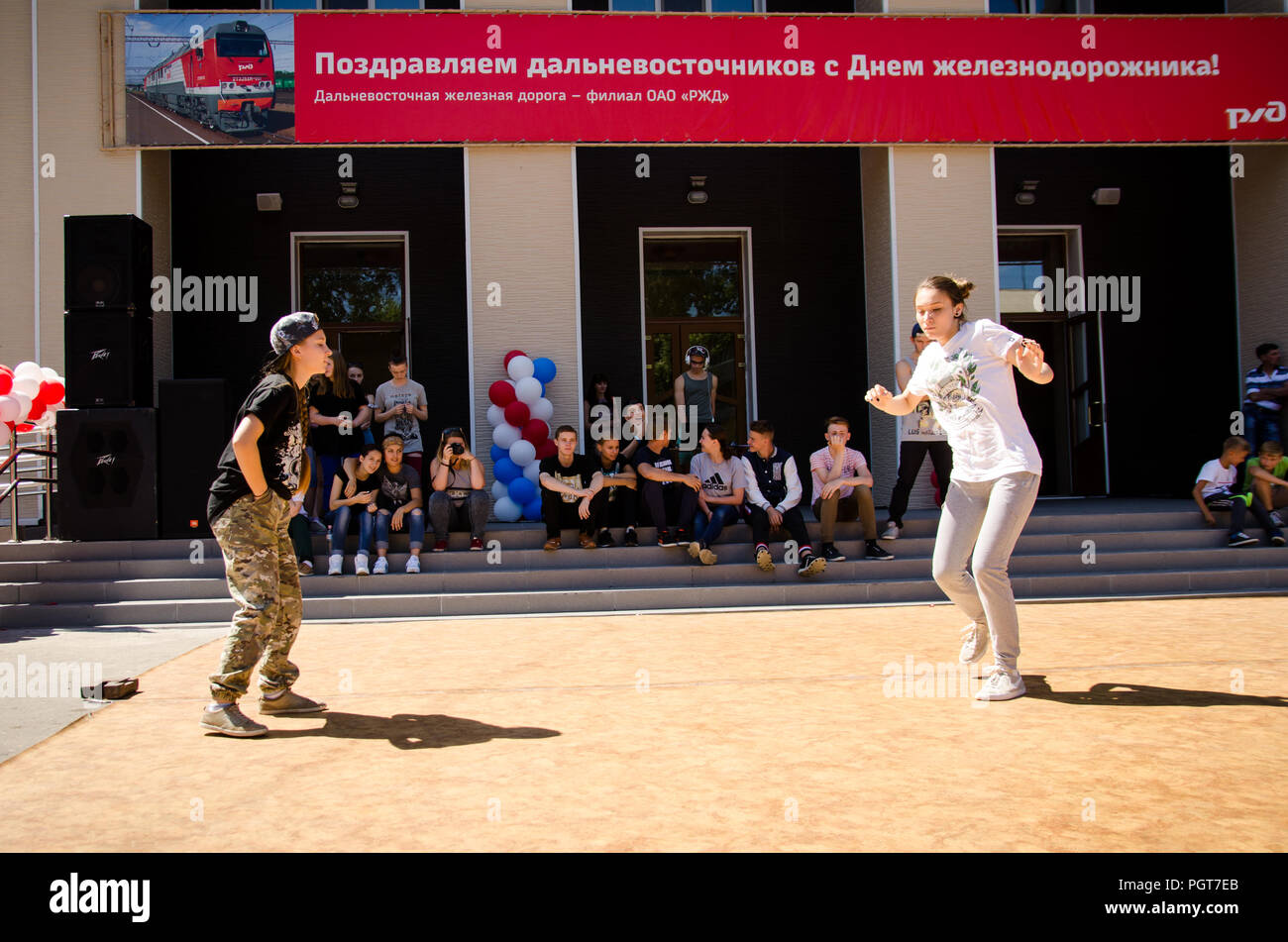 Komsomolsk-on-Amur, Russia, 1 August, 2015. two girsl dances breakdance in the square with spectators Stock Photo