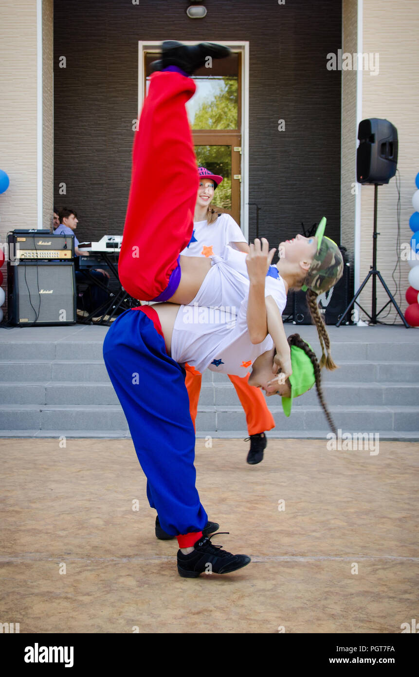 Komsomolsk-on-Amur, Russia, August 1, 2015. Railroader's day. Two girls in hiphop costumes dancing on the street scene. Stock Photo