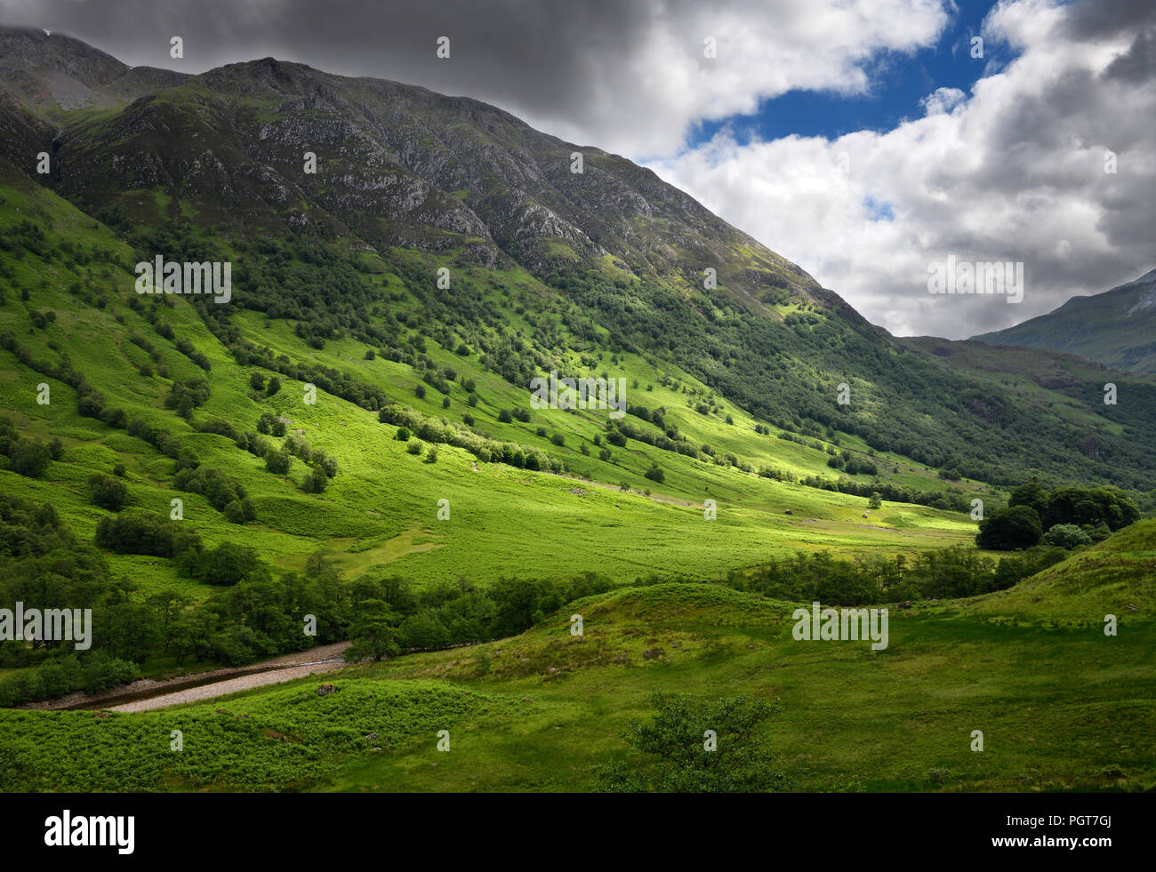 Five Finger Gulley leading up to cloud covered Ben Nevis mountain and green slopes to River Nevis Scottish Highlands Scotland UK Stock Photo