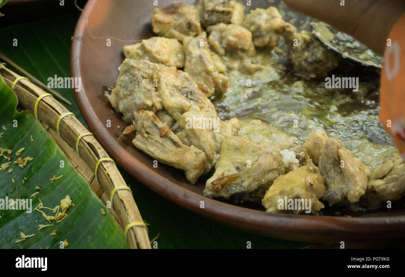Opor Ayam Javanese indonesia white chicken curry, served in traditional clay plate in central java indonesia Stock Photo