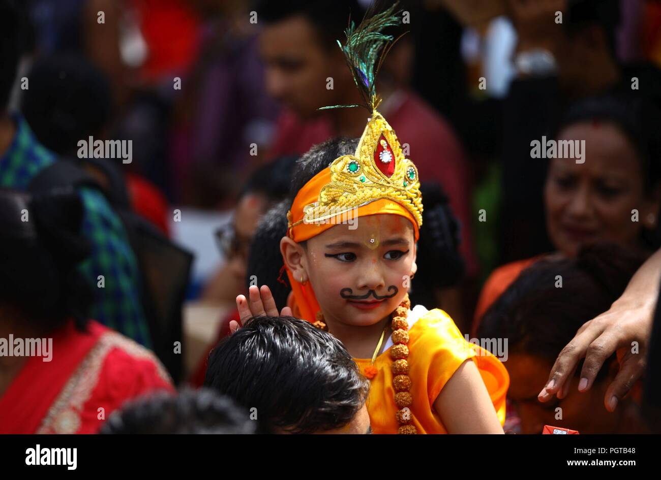 Kathmandu, Nepal. 27th Aug, 2018. A Kid dressed up as Lord Krishna takes part in celebration of Gaijatra festival or the festival of cows in Kathmandu. Hindus celebrated the festival in commemorate of the death loved ones and pray for peace soul honouring cows or decorate people as cow in the streets. Credit: Archana Shrestha/Pacific Press/Alamy Live News Stock Photo