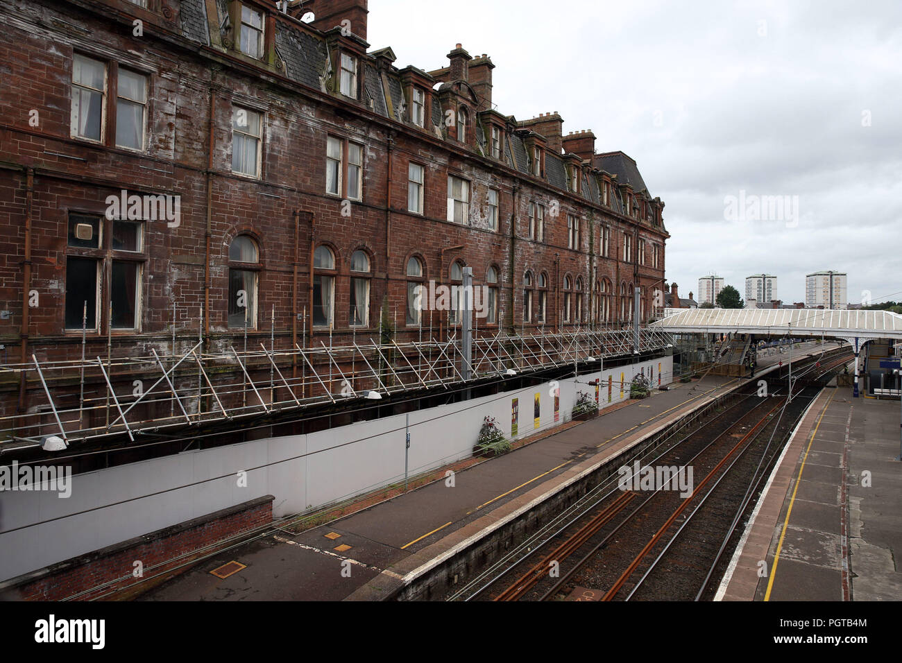 The former Station Hotel(left) in Ayr sitting next to the nearby railway line, the building has has been deemed unsafe after contractors found crumbling and exposed roof areas, resulting in an exclusion zone which has meant that no trains are running between Ayr and Girvan from Tuesday, while services between Glasgow Central and Stranraer are starting and terminating at Kilmarnock. Stock Photo