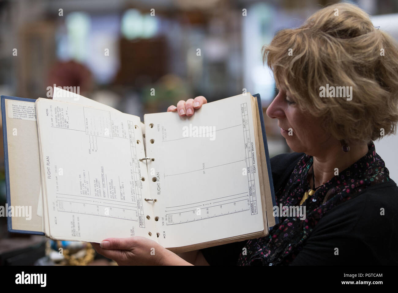 Jill Gallone, head of media and advertising at Hansons Auctioneers in Derbyshire, holds the Apollo 15 Flight Plan. A space exploration collection is set to go to auction which includes items from the Apollo space missions. Stock Photo