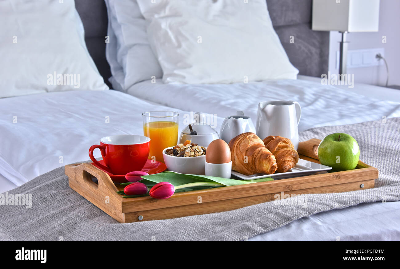 Breakfast on tray in bed in hotel room Stock Photo - Alamy