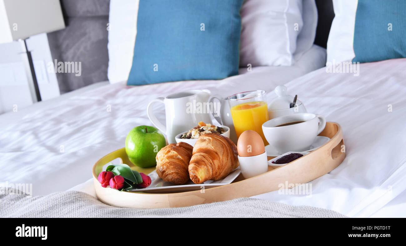 Breakfast on tray in bed in hotel room Stock Photo - Alamy