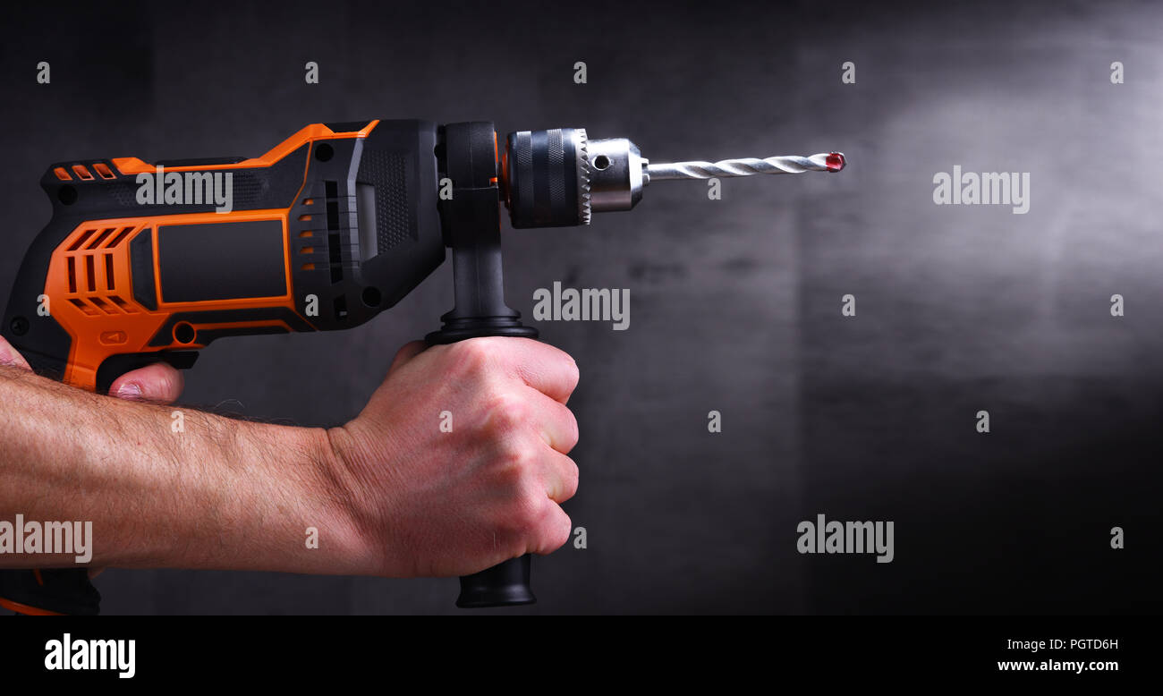 https://c8.alamy.com/comp/PGTD6H/male-hands-holding-power-drill-PGTD6H.jpg