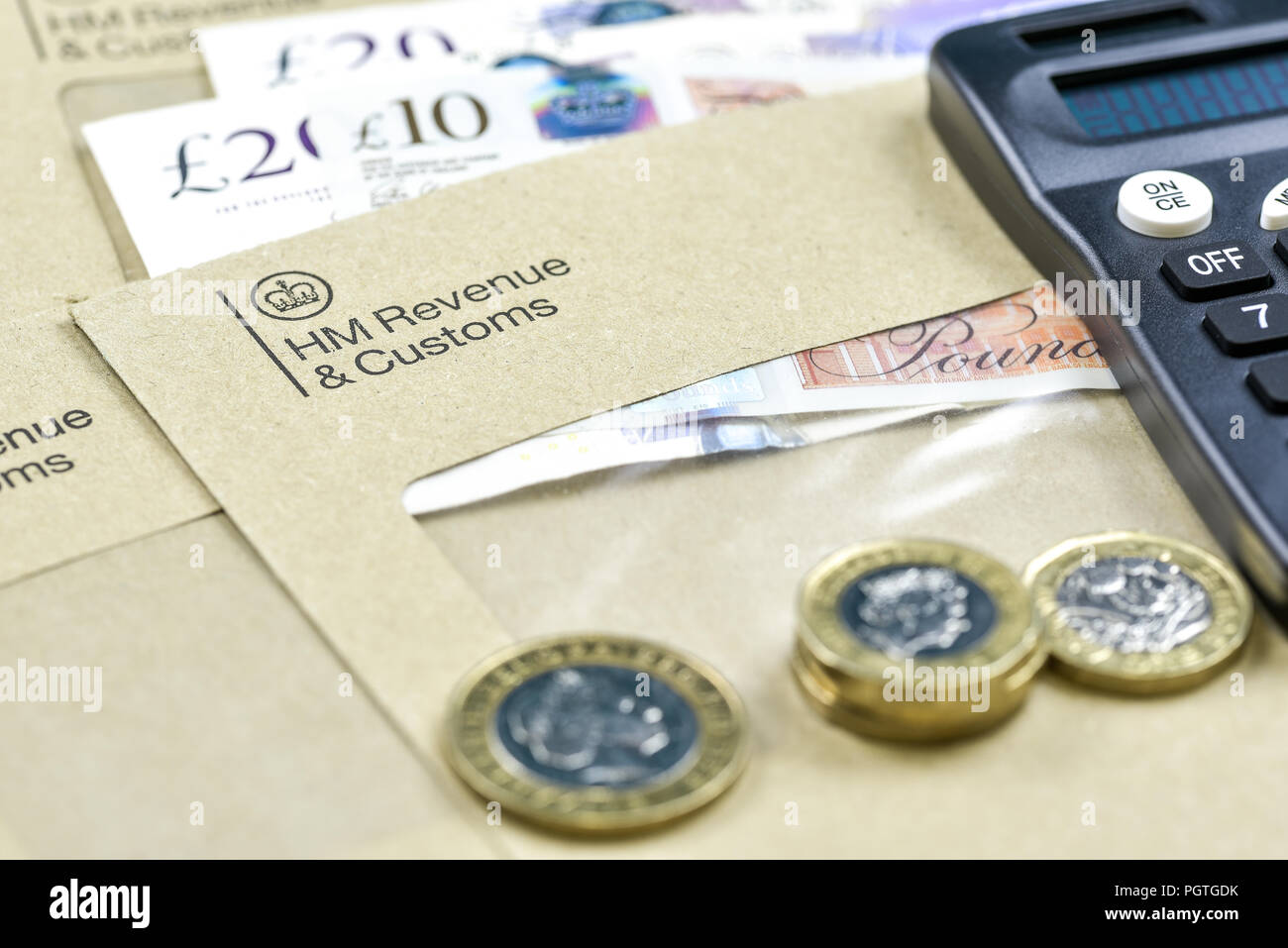 England, UK - August 16 2018: The logo of Her Majestys Revenue and Customs on envelope, with money or check included inside.  HMRC is a non-ministeria Stock Photo