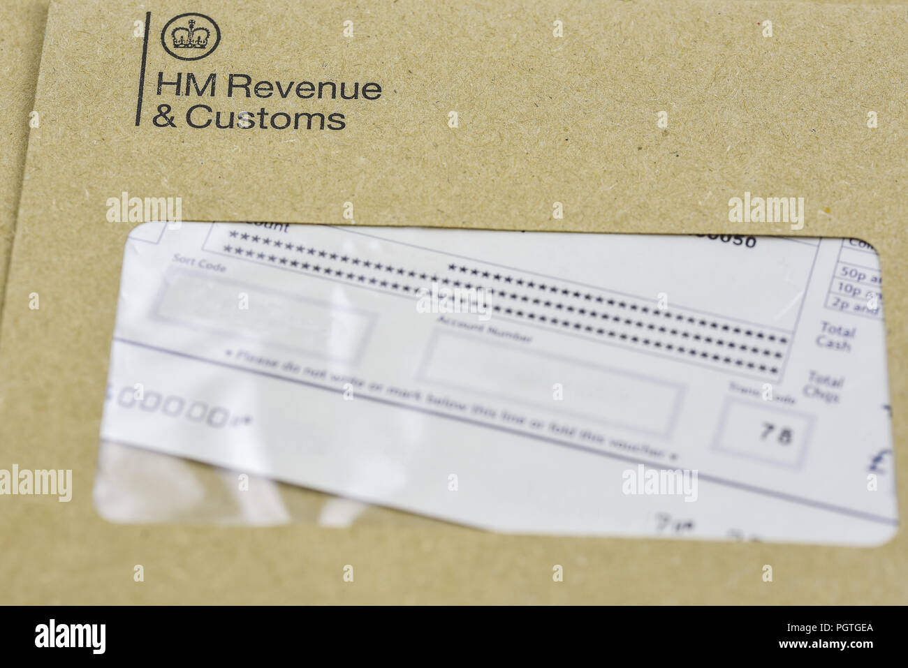England, UK - August 16 2018: The logo of Her Majestys Revenue and Customs  on envelope, with money or check included inside. HMRC is a non-ministeria  Stock Photo - Alamy