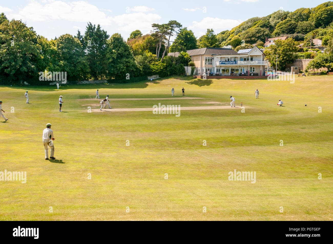 A cricket match in progress at the ground of Ventnor Cricket Club on the Isle of Wight. Stock Photo