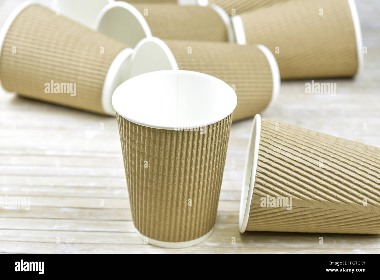 Brown cardboard take away disposable paper cups with white lid Stock