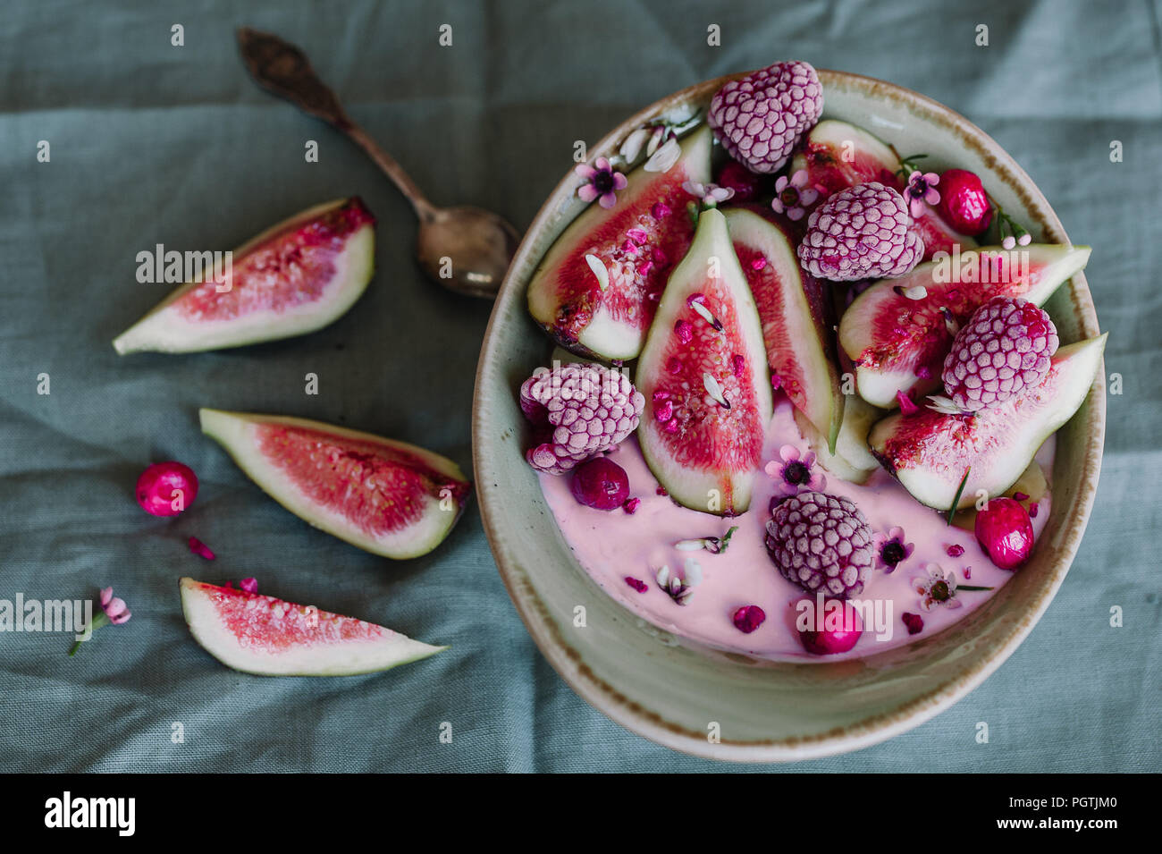 Healthy breakfast bowl with yogurt, fresh figs and frozen berries Stock Photo