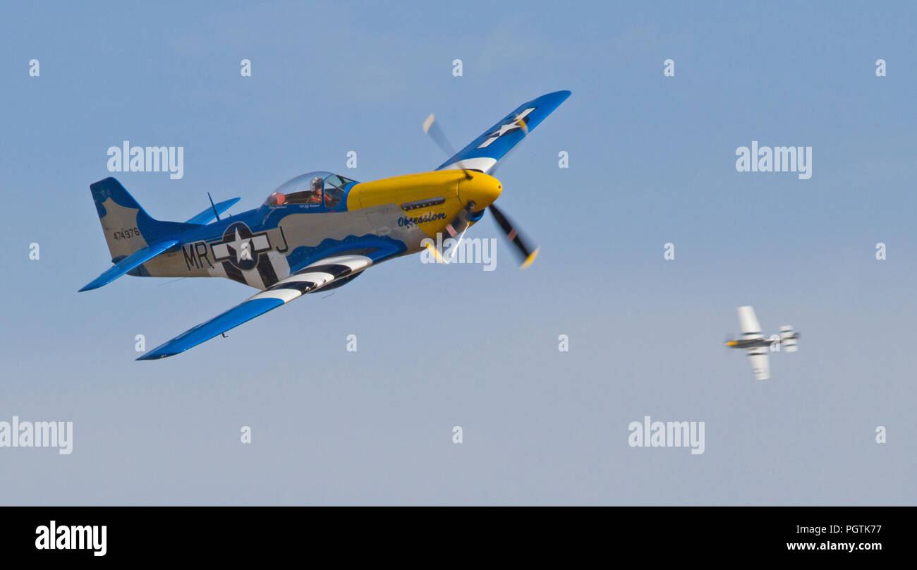 MONROE, NC - NOVEMBER 8, 2014:  Two P-51 Mustang Fighters Performing at the Warbirds Over Monroe Air Show in Monroe, NC. Stock Photo