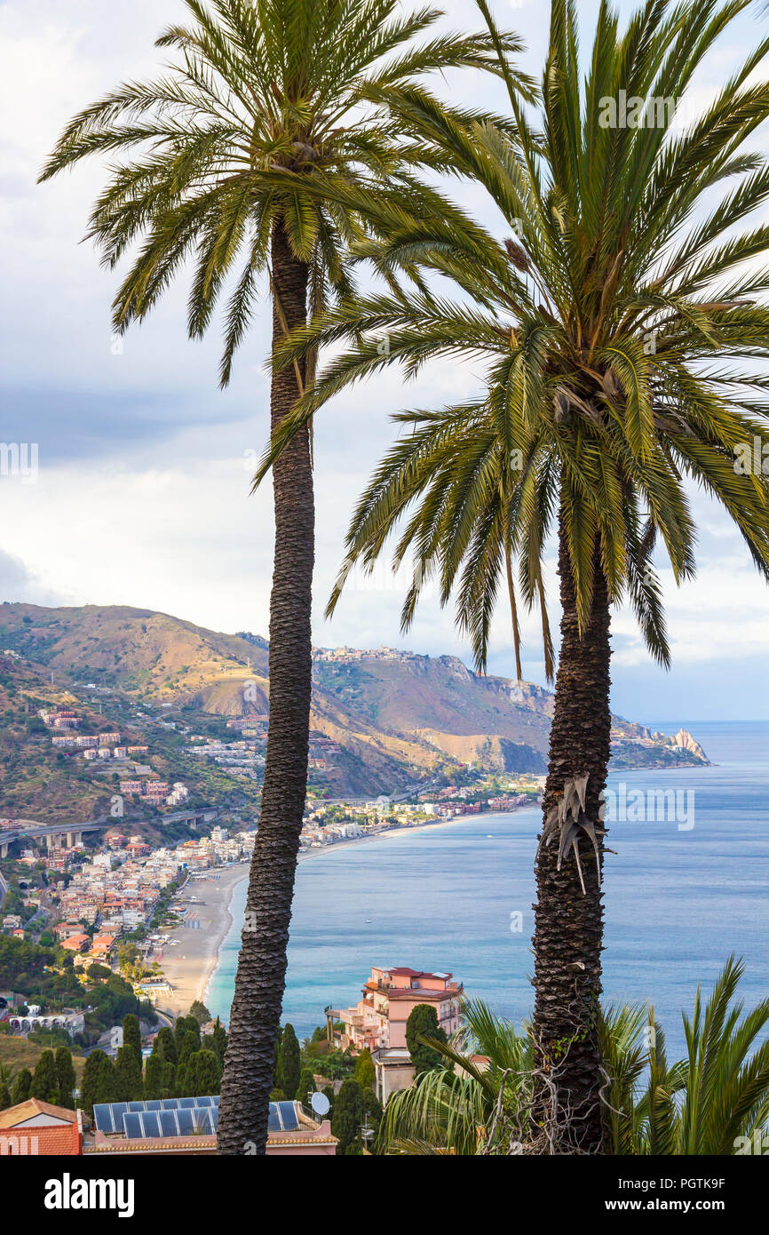 Beautiful scenery with Mediterranean sea, beaches and palm trees seen from Taormina, Sicily, Italy Stock Photo
