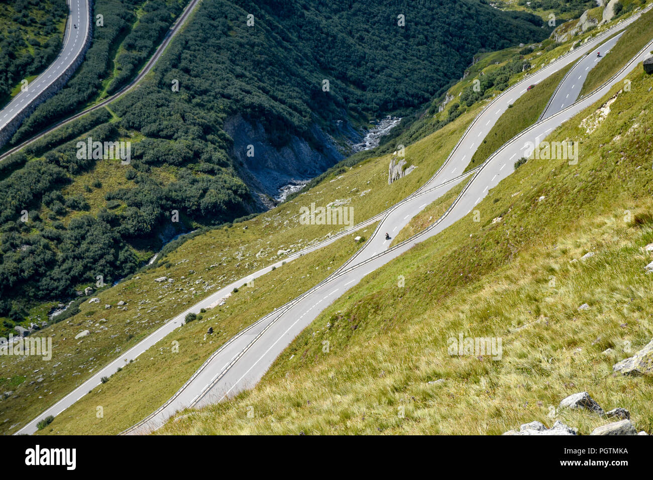 Winding roads looking like waves in the Swiss Alps Stock Photo