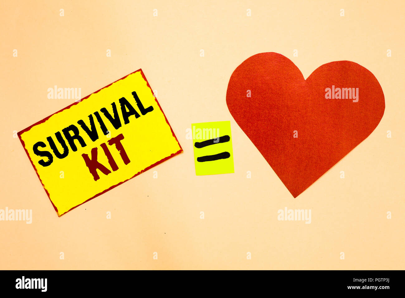 Handwriting text writing Survival Kit. Concept meaning Emergency Equipment Collection of items to help someone Yellow piece paper reminder equal sign  Stock Photo