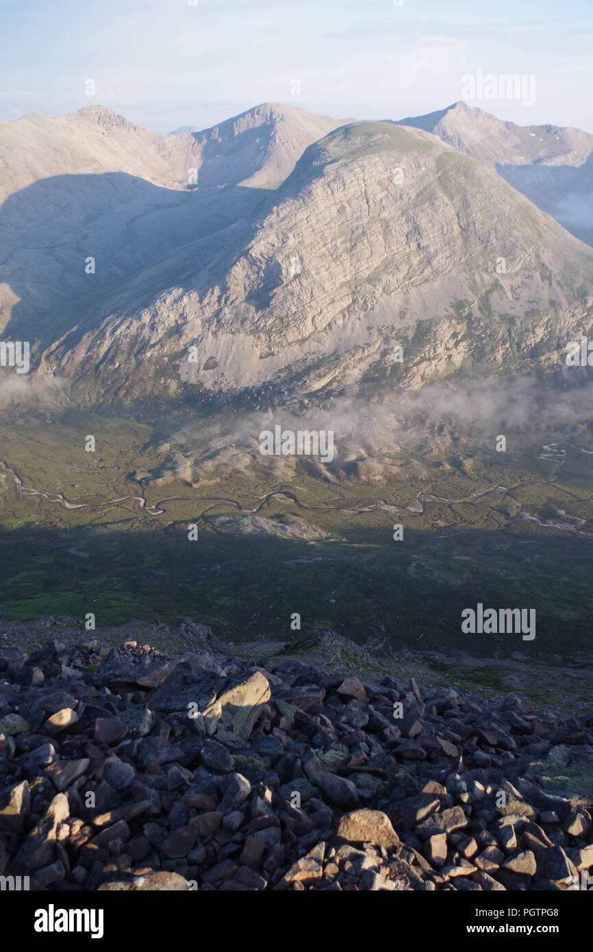 Meandering Burn Stream along the Valley Floor Under Slight Cloud Inversion. Birds Eye View from Meall a'Ghiubhais Mountain. Kinlochewe, Torridon, UK. Stock Photo