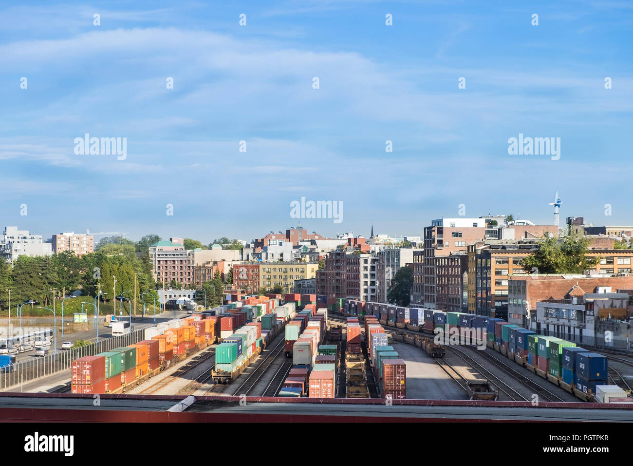Rail cars loaded with containers wait at the waterfront rail yard in Vancouver British Columbia Canada. Stock Photo