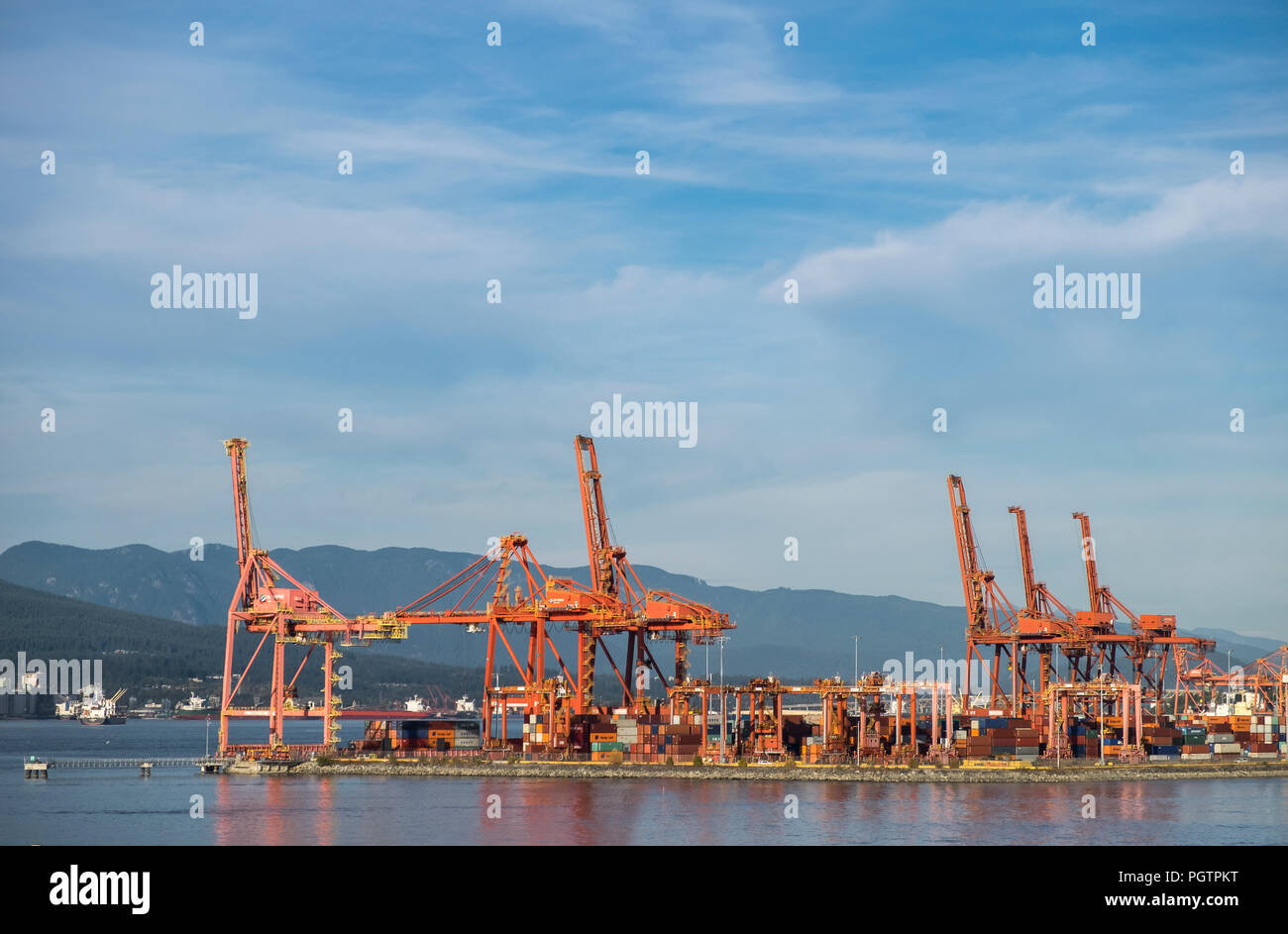 Orange cranes at the container port in Vancouver British Columbia Canada. Stock Photo