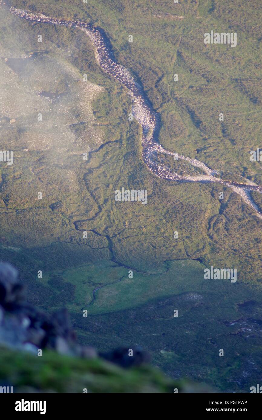 Meandering Burn Stream along the Valley Floor Under Slight Cloud Inversion. Birds Eye View from Meall a'Ghiubhais Mountain. Kinlochewe, Torridon, UK. Stock Photo