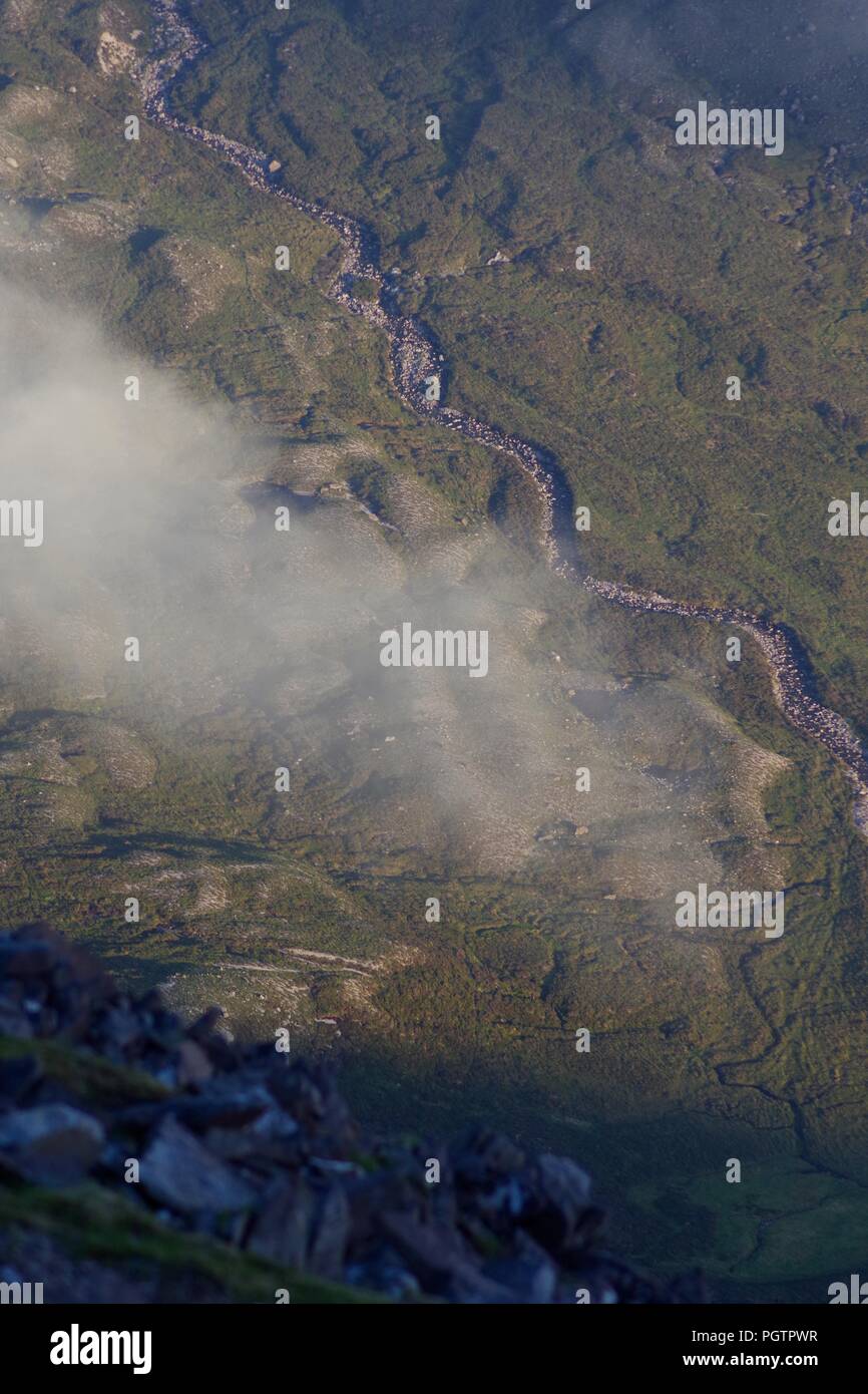 Meandering Burn Stream along the Valley Floor Under Slight Cloud Inversion. Birds Eye View from Meall a'Ghiubhais Mountain. Kinlochewe, Torridon, UK. Stock Photo