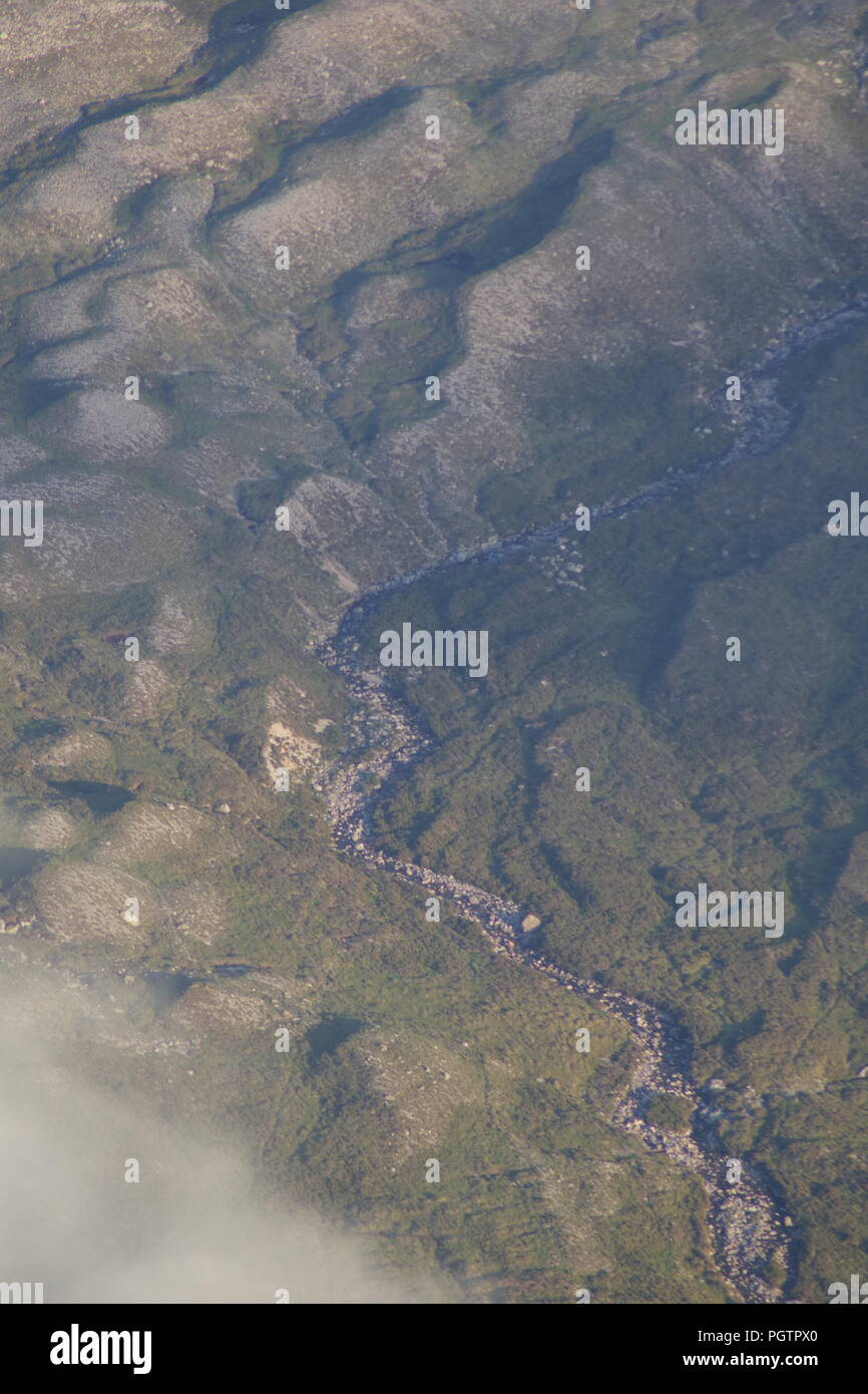 Meandering Burn Stream along the Valley Floor Under Slight Cloud Inversion. Birds Eye View from Meall a'Ghiubhais Mountain. Kinlochewe, Torridon, UK. Stock Photo