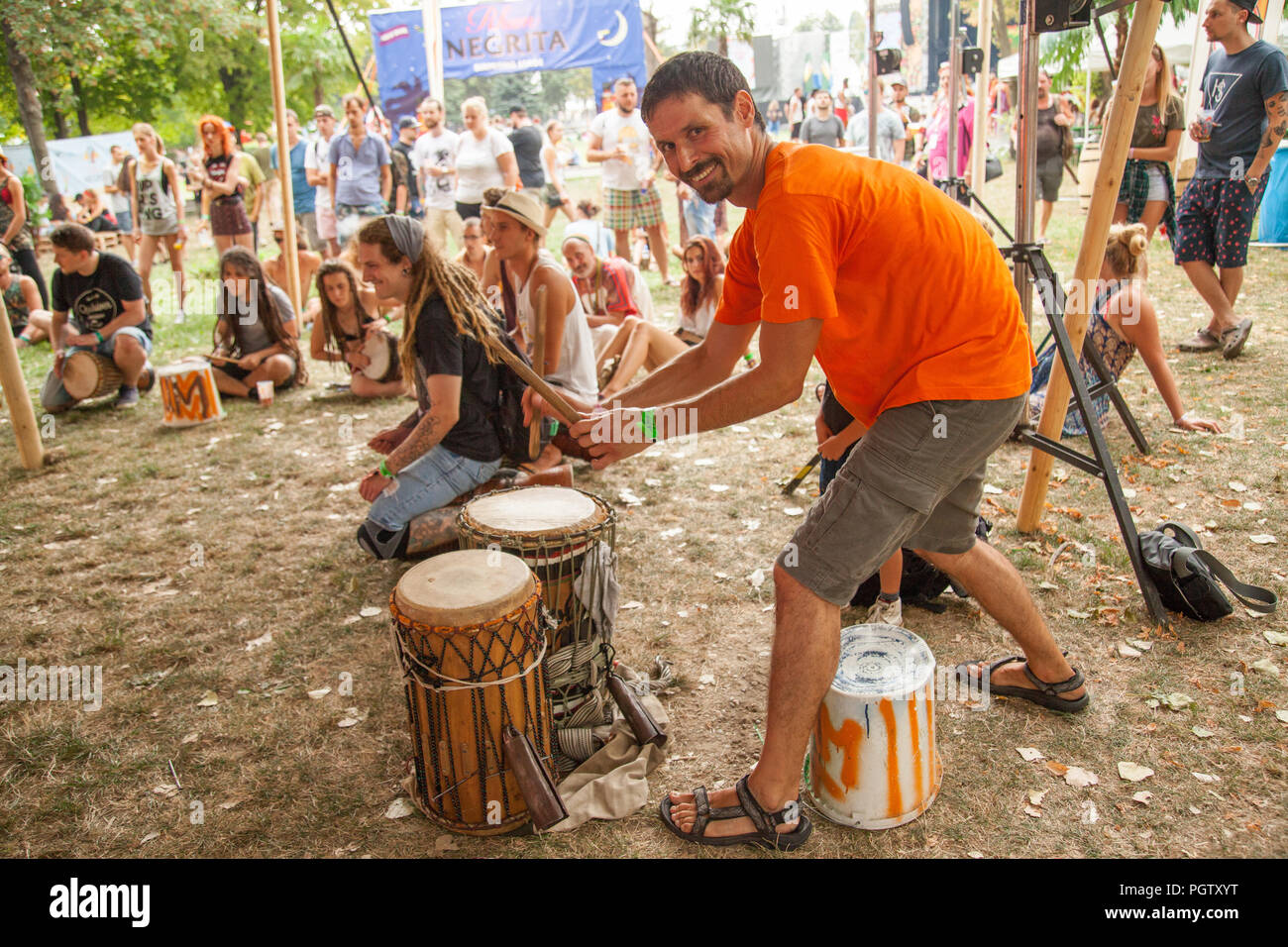 Bratislava, Slovakia. 24th August, 2018. Visitors to the Uprising Music Festival drum and enjoy their time. Stock Photo